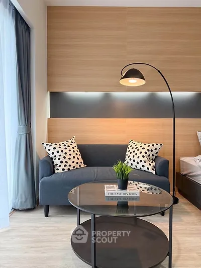 Modern living room with stylish sofa and floor lamp, perfect for cozy relaxation.