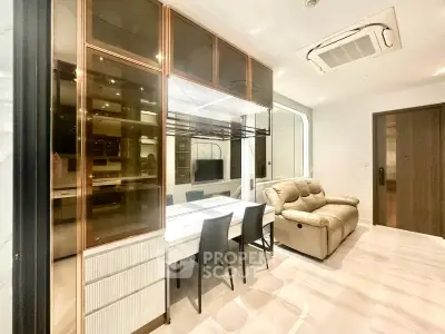 Modern living room with sleek furniture and integrated air conditioning in a stylish apartment.