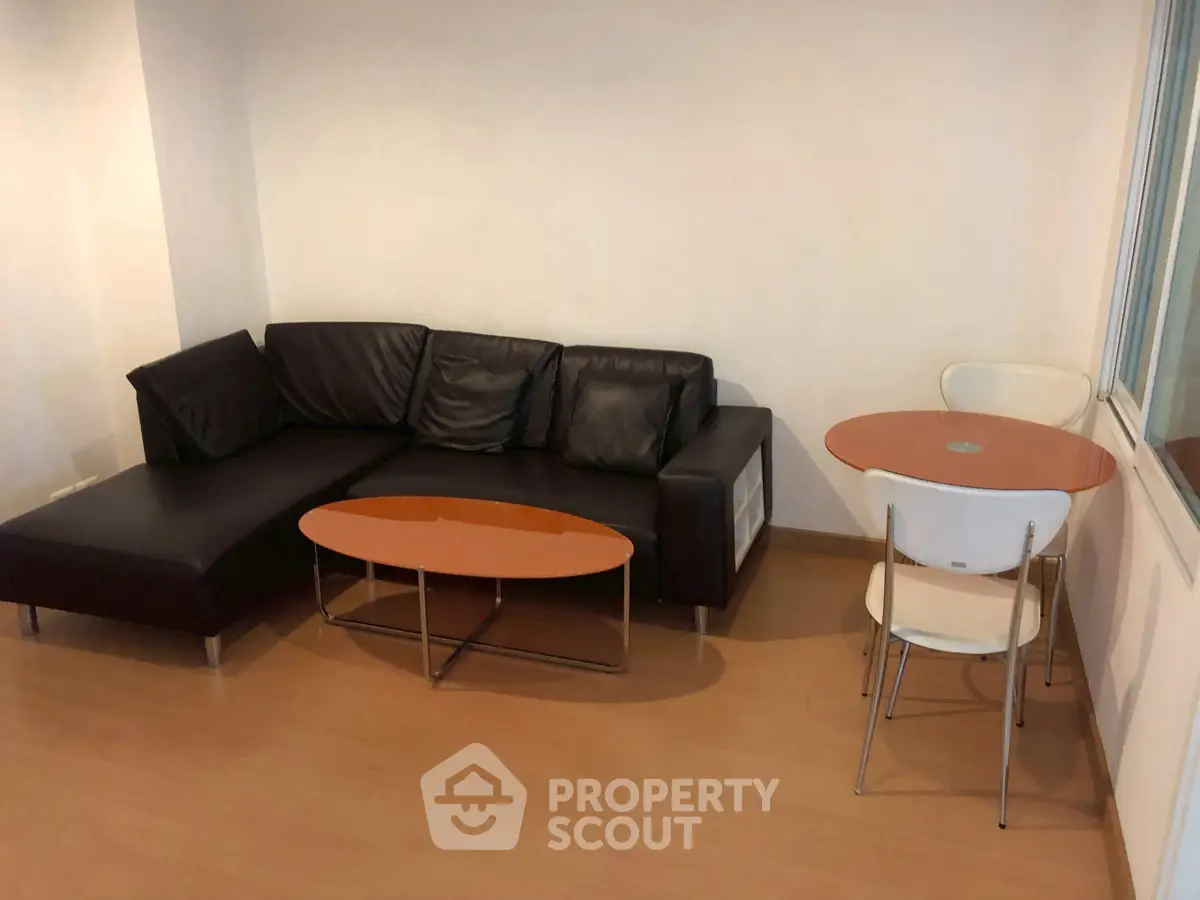 Modern living room with sleek black sofa and stylish coffee table