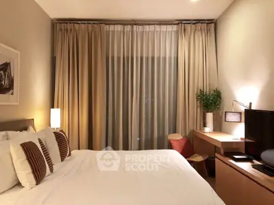 Elegant bedroom with cozy lighting and modern decor, featuring a comfortable bed and stylish workspace.