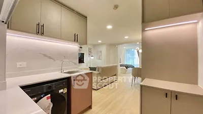 Modern open-plan kitchen and living area with sleek design and integrated appliances.