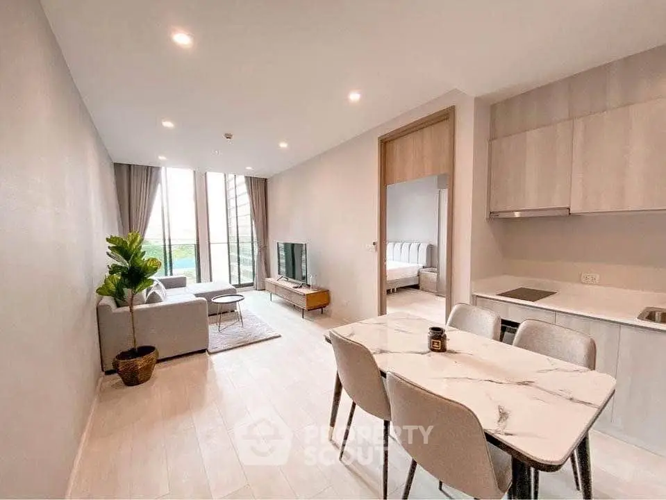 Modern open-plan living room with dining area and kitchen in a stylish apartment
