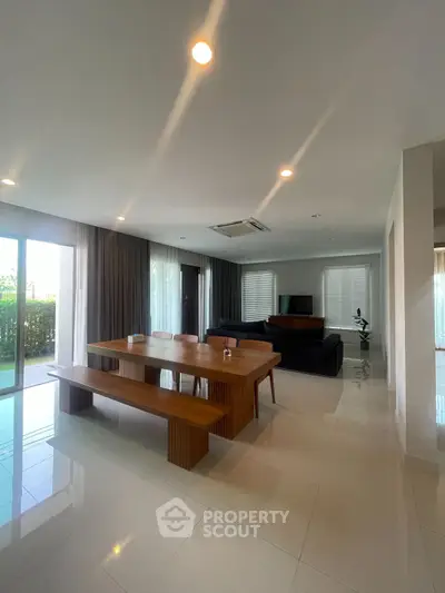 Spacious modern living room with elegant dining area and large windows