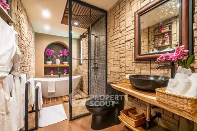 Luxurious bathroom with stone walls, modern fixtures, and elegant decor