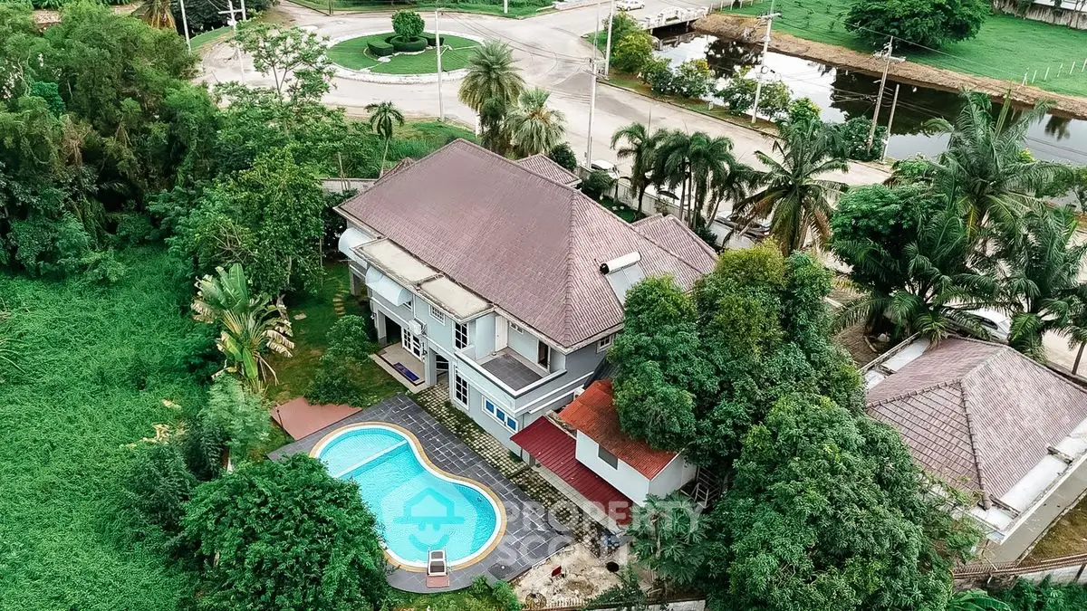 Luxurious estate with private pool and lush greenery, perfect for serene living.
