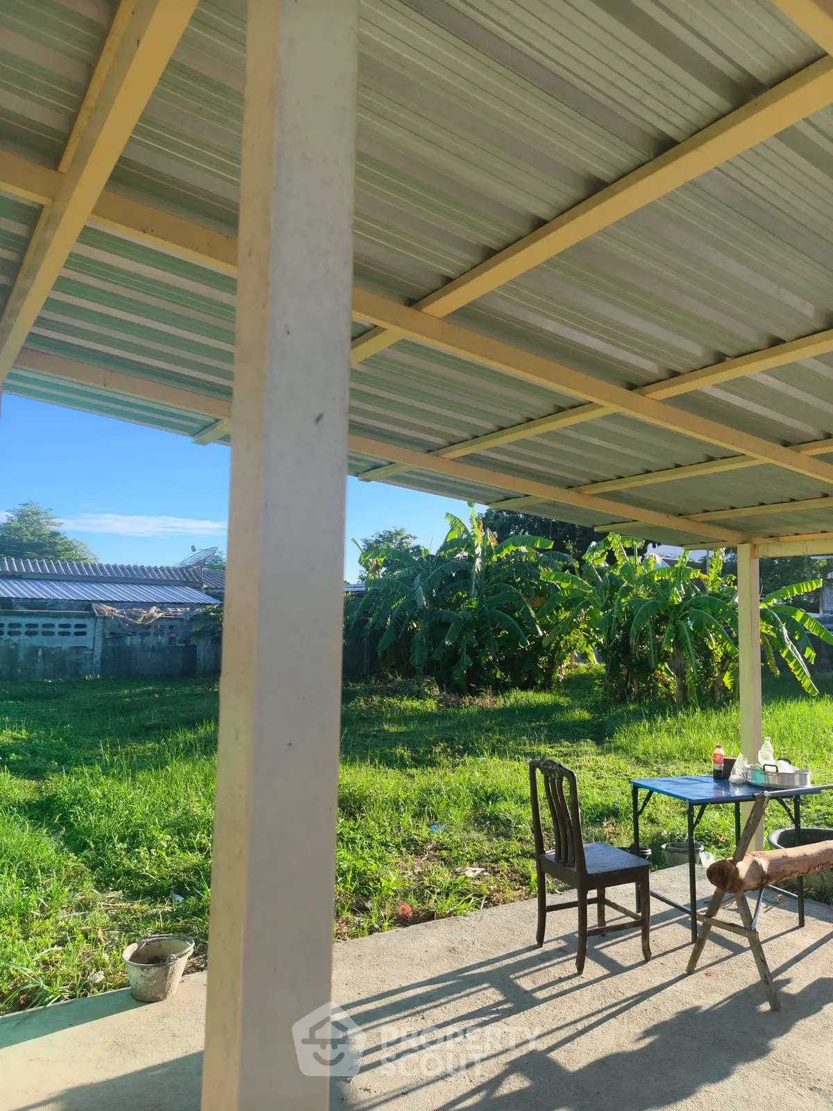 Charming outdoor patio with lush garden view, perfect for relaxation and entertaining.