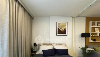 Cozy bedroom with modern decor and soft lighting, featuring a comfortable bed and stylish wall art.
