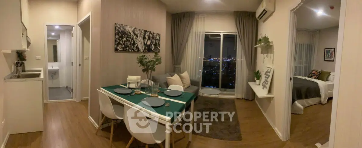 Modern apartment interior with dining area and city view, featuring stylish decor and cozy ambiance.