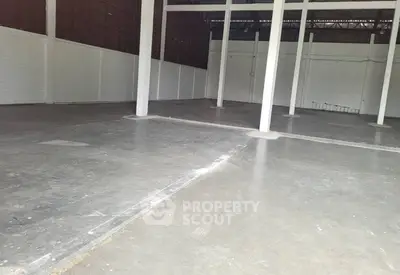 Spacious industrial warehouse with high ceilings and open floor plan.