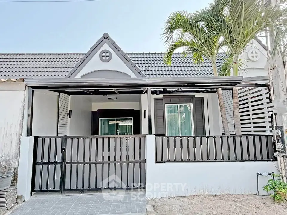 Charming single-story home with modern facade and gated entrance, perfect for cozy living.