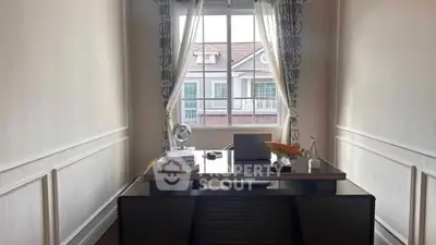 Elegant study room with modern desk and window view in stylish home office.