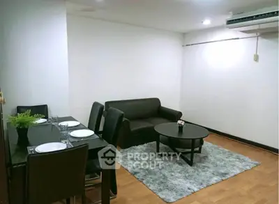 Cozy living room with modern furniture and dining area, perfect for urban living.