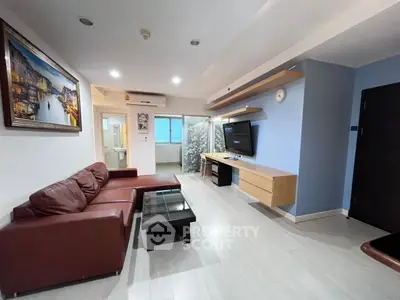 Spacious living room with modern decor and leather sofa in a stylish apartment.