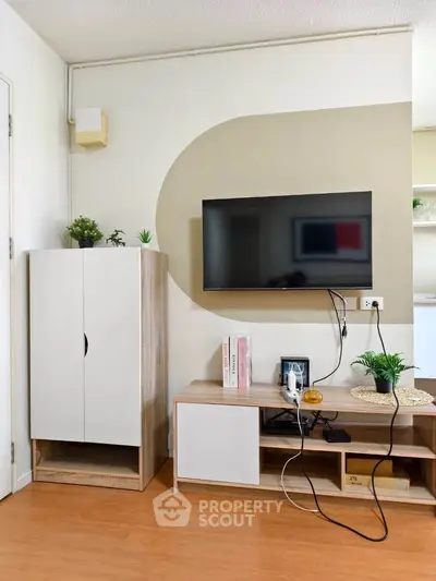 Modern living room with wall-mounted TV and stylish storage units
