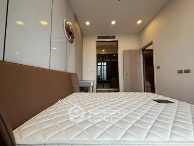 Modern bedroom with sleek design and comfortable mattress in a stylish apartment.