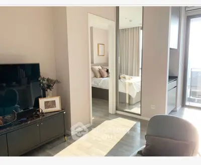 Modern apartment interior with stylish living room and cozy bedroom, featuring natural light and elegant decor.