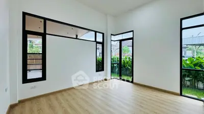 Spacious modern room with large windows and garden view, perfect for natural light lovers.