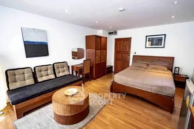 Spacious studio apartment with modern furnishings and wooden flooring