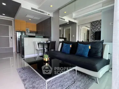 Modern living room with sleek furniture and open kitchen layout in a stylish apartment.