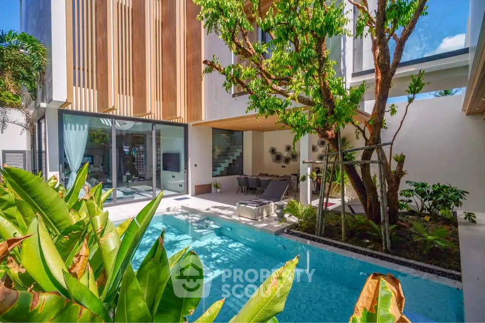 Luxurious modern villa with private pool and lush garden, featuring sleek architecture and spacious outdoor living area.