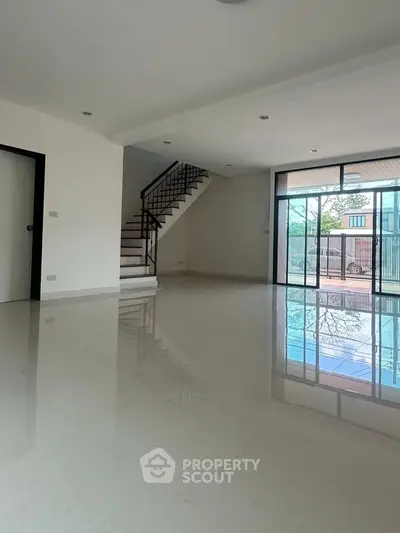 Spacious modern living room with glossy floors and large windows