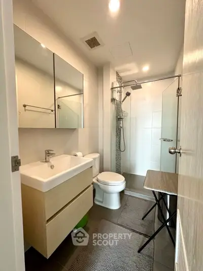 Modern bathroom with sleek fixtures and glass shower enclosure