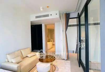 Modern living room with elegant decor and a glimpse of a luxurious bathroom