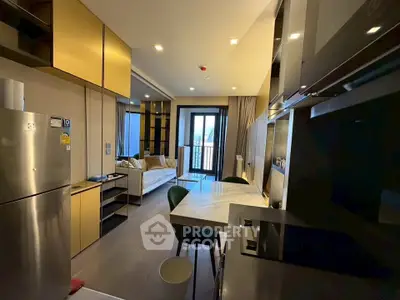 Modern open-layout kitchen and living room with sleek design and natural light.