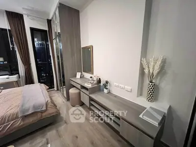 Modern bedroom with stylish decor and city view, featuring sleek furniture and elegant design.