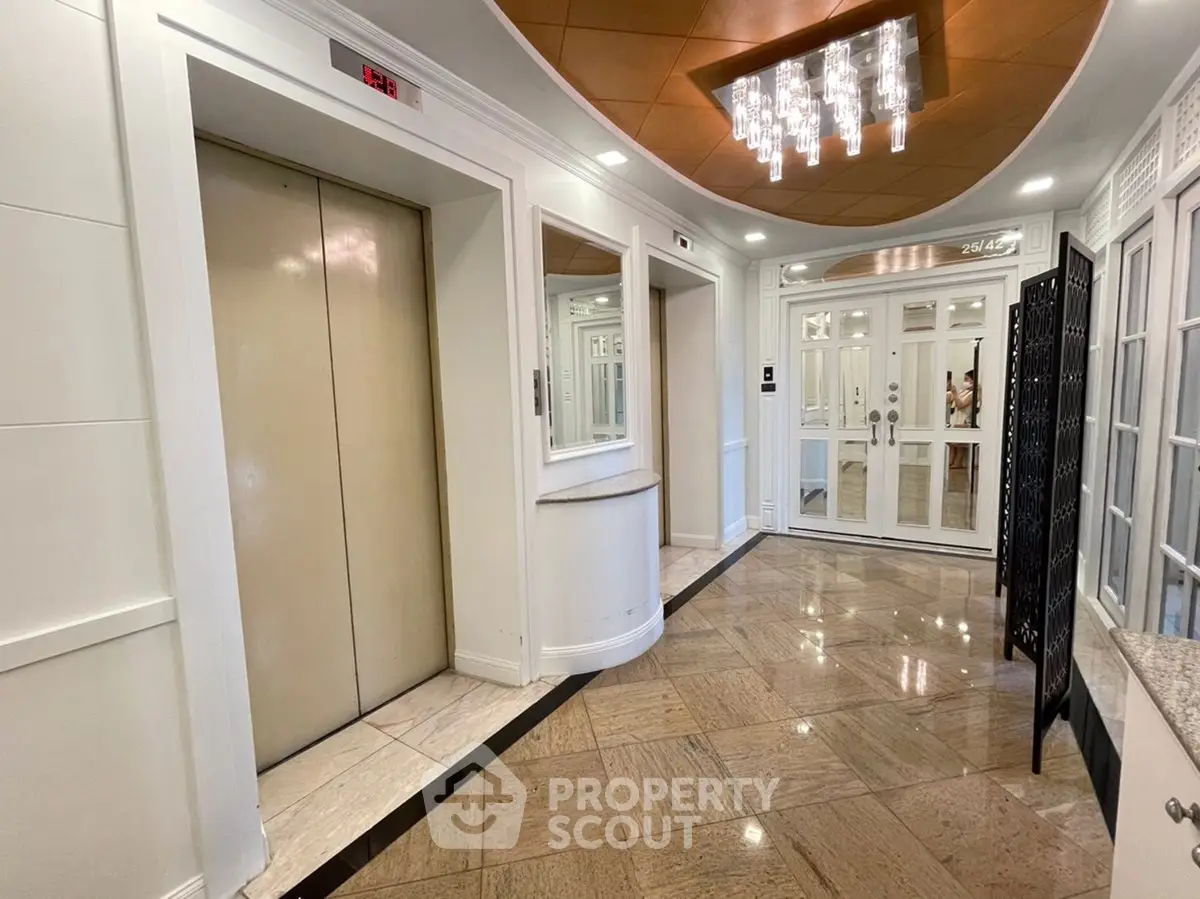 Elegant building entrance with modern elevator and stylish lighting