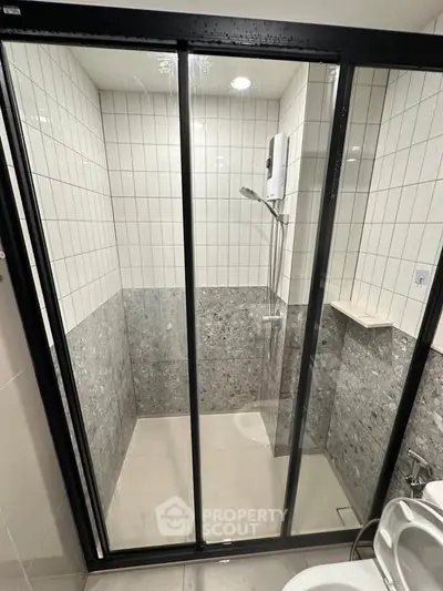 Modern bathroom with sleek shower enclosure and stylish tile design
