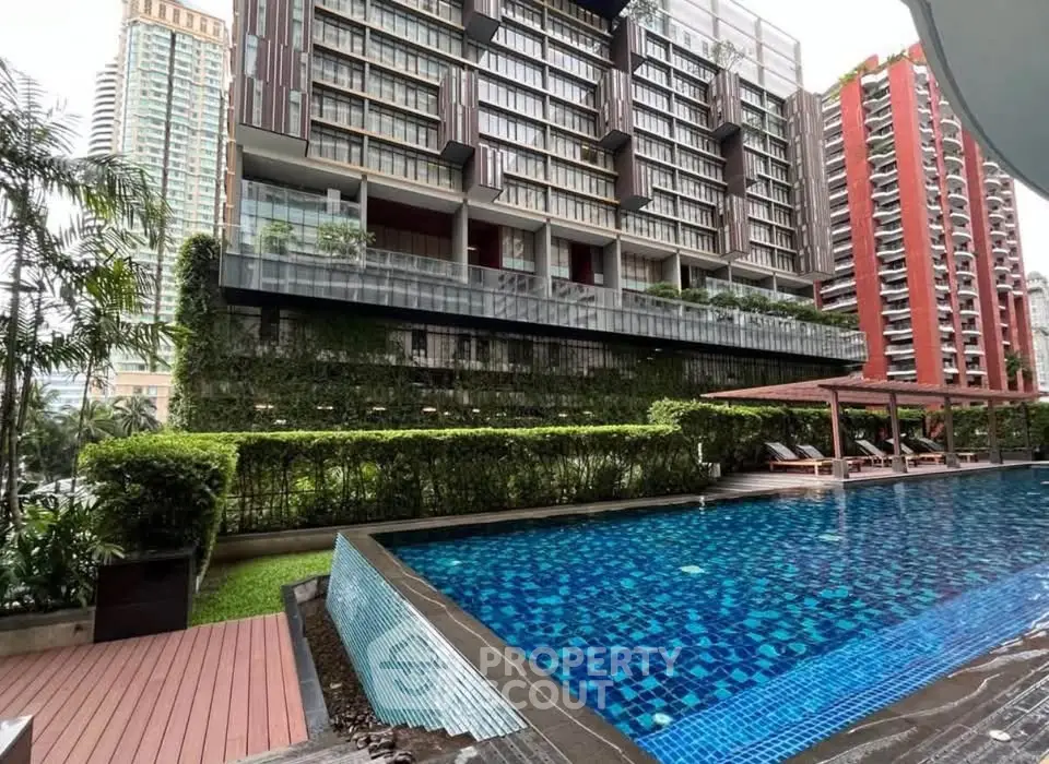 Luxurious condominium with stunning pool and lush greenery in urban setting