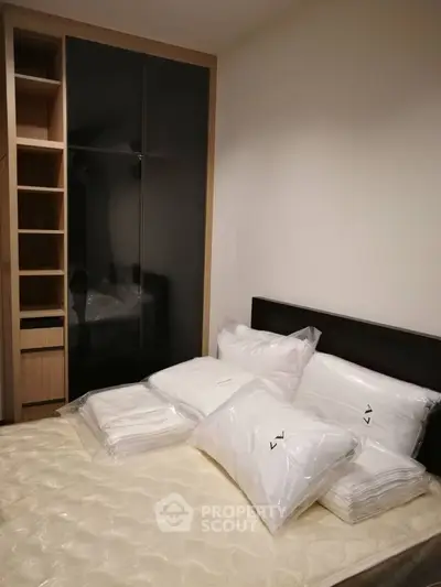 Cozy bedroom with modern wardrobe and neatly arranged bedding