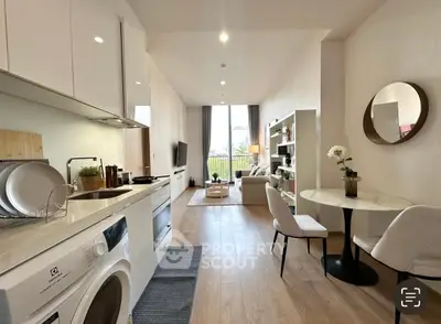 Modern open-plan kitchen and living room with stylish decor and natural light.