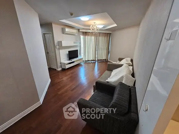 Spacious living room with elegant hardwood floors and modern furnishings.