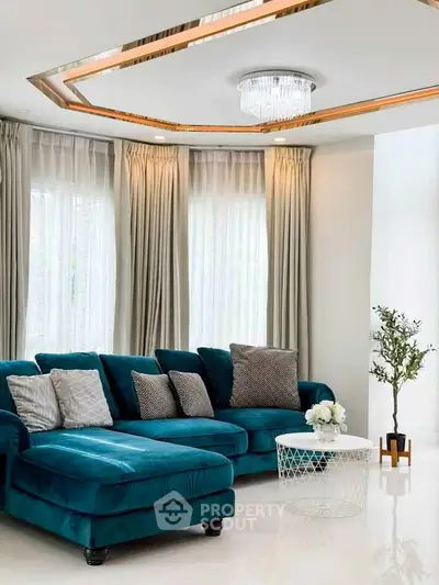 Luxurious living room with elegant teal sofa and modern decor