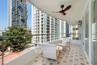 Spacious balcony with modern chairs and city view in high-rise building
