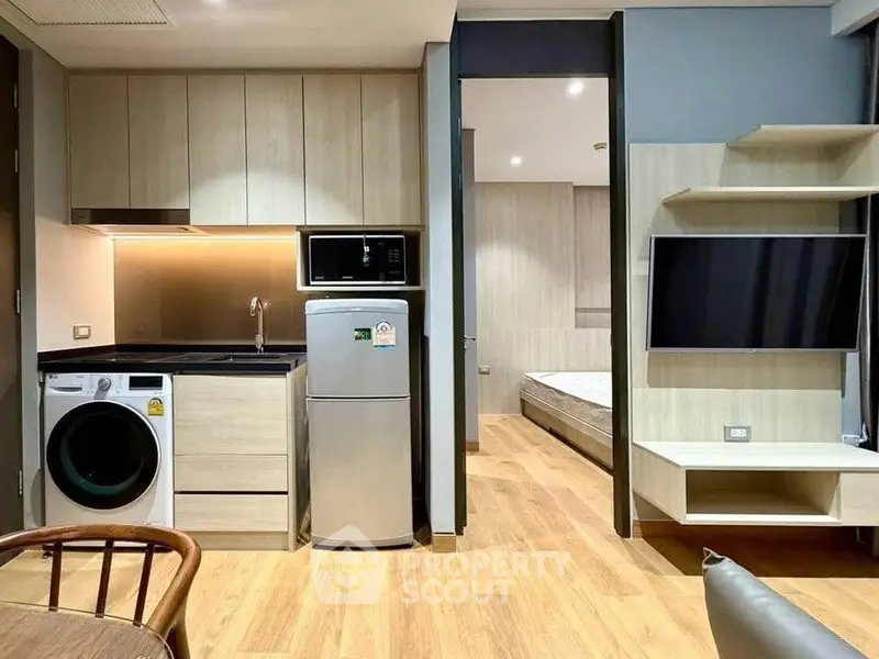 Modern studio apartment with compact kitchen and cozy living area