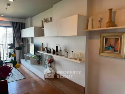 Stylish living room with modern shelving and elegant decor in a high-rise apartment.