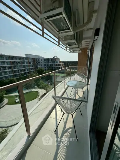 Modern balcony with stylish chairs and scenic view of residential complex