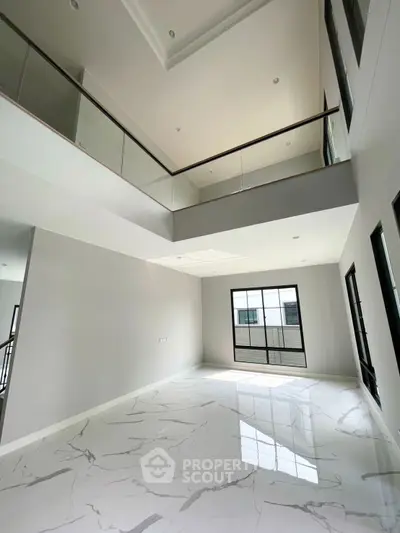 Spacious modern living room with high ceilings and elegant marble flooring