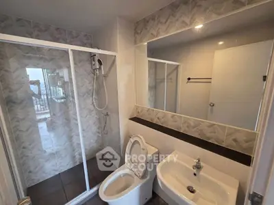 Modern bathroom with glass shower and sleek fixtures