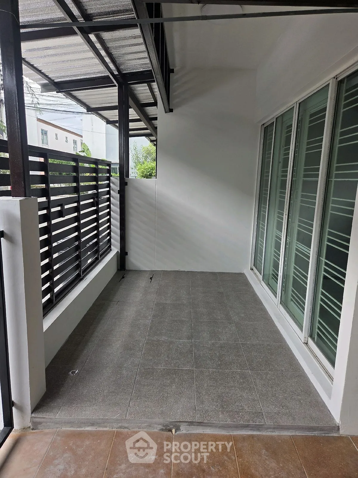 Spacious balcony with modern design and tiled flooring, perfect for relaxation.