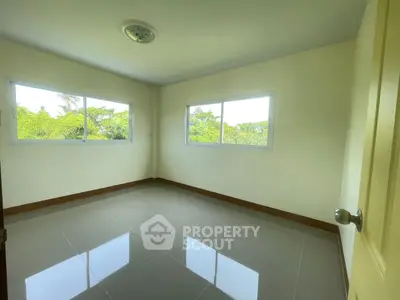 Bright empty room with large windows and glossy tiled floor, ideal for customization.
