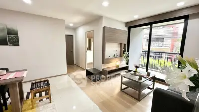 Modern living room with sleek furniture and large windows offering natural light.