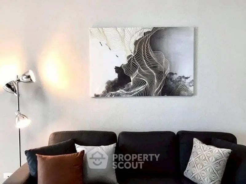 Modern living room with stylish sofa and abstract wall art.