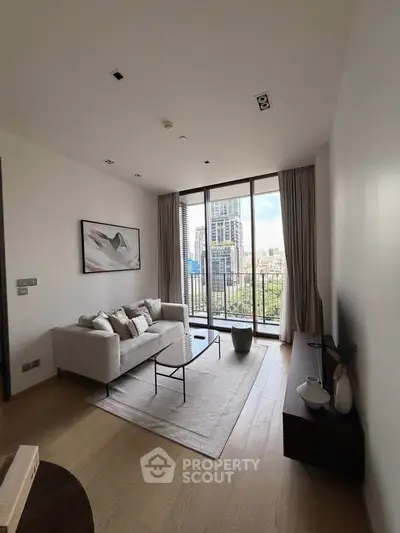 Modern living room with floor-to-ceiling windows and city view, featuring elegant decor and cozy seating.