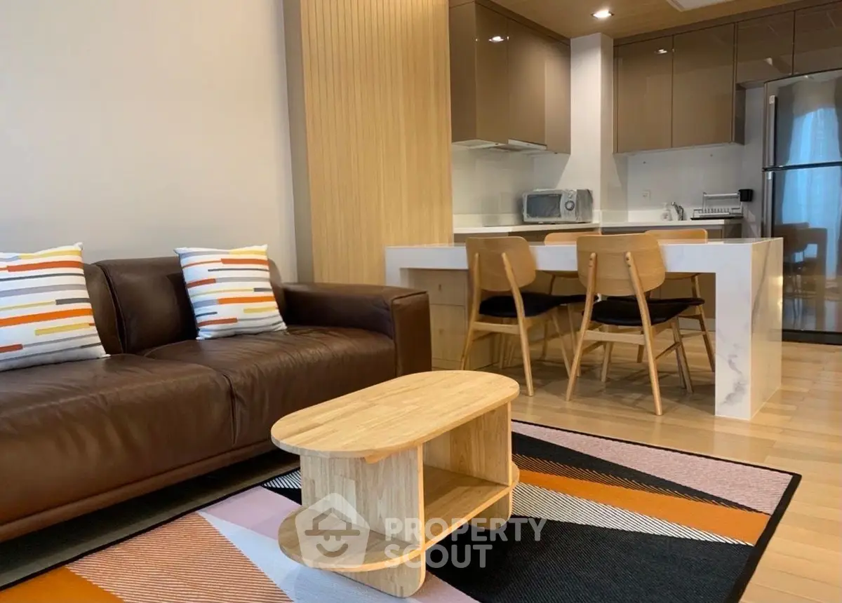 Modern living room with stylish kitchen and cozy seating area