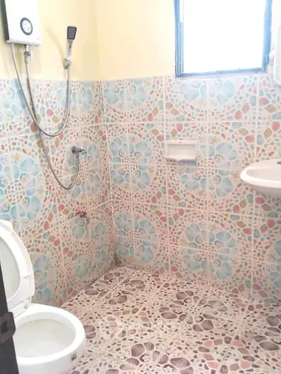 Charming bathroom with colorful mosaic tiles and modern fixtures, perfect for a cozy home.