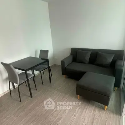 Modern minimalist living room with sleek furniture and wooden flooring